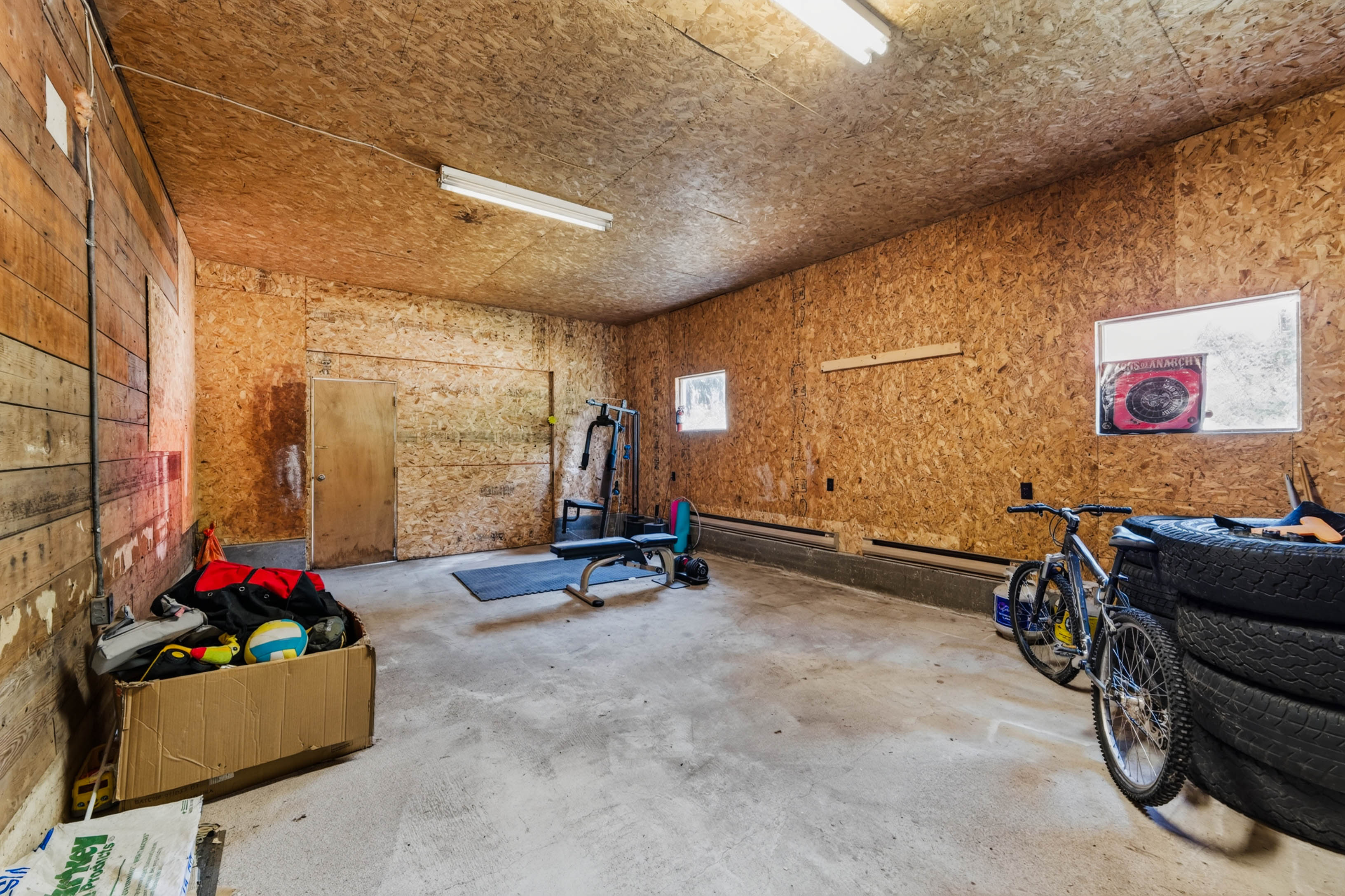 Large wood-lined workshop with concrete floor