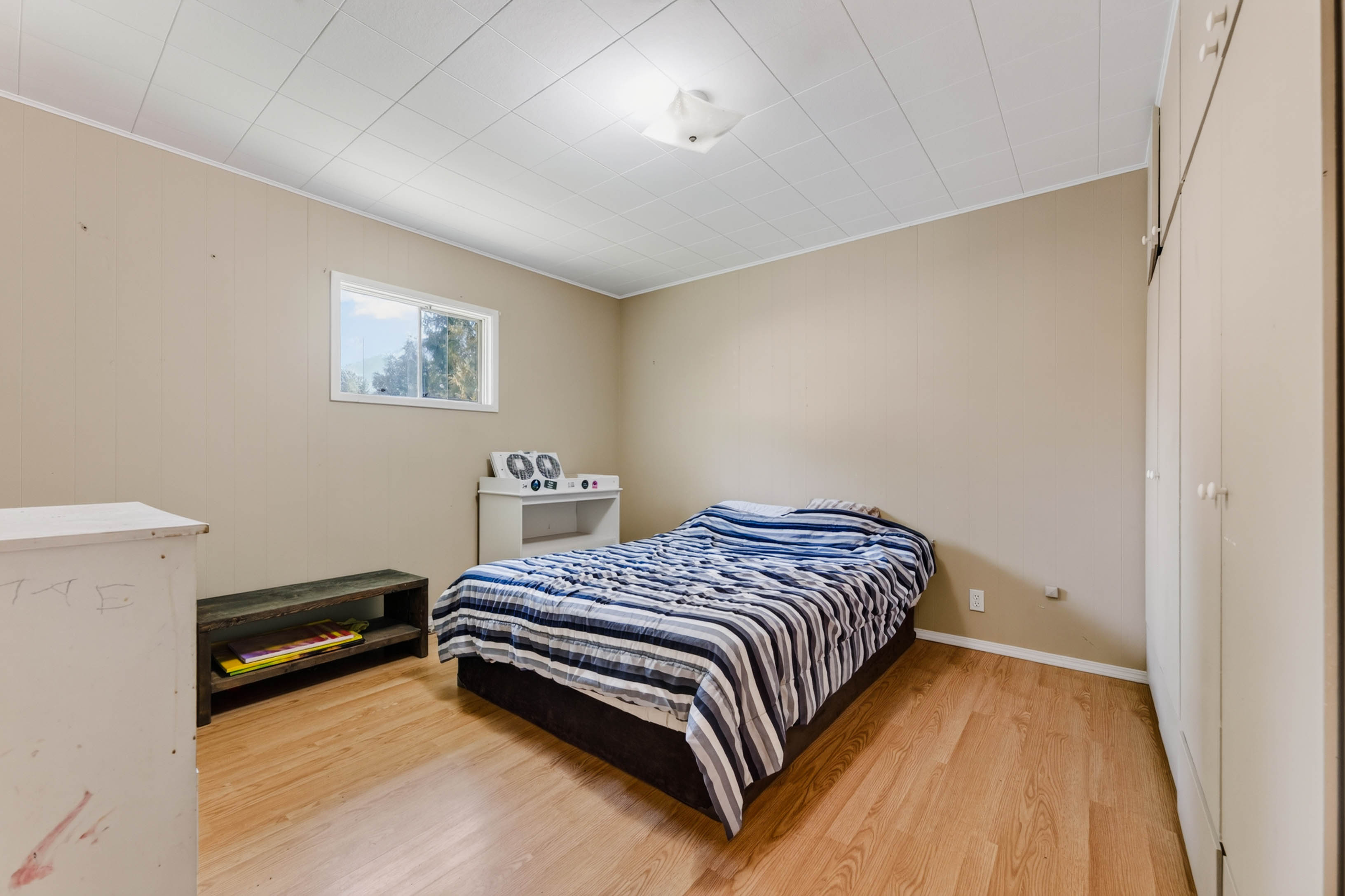 Second bedroom with wood-look flooring and built-in storage