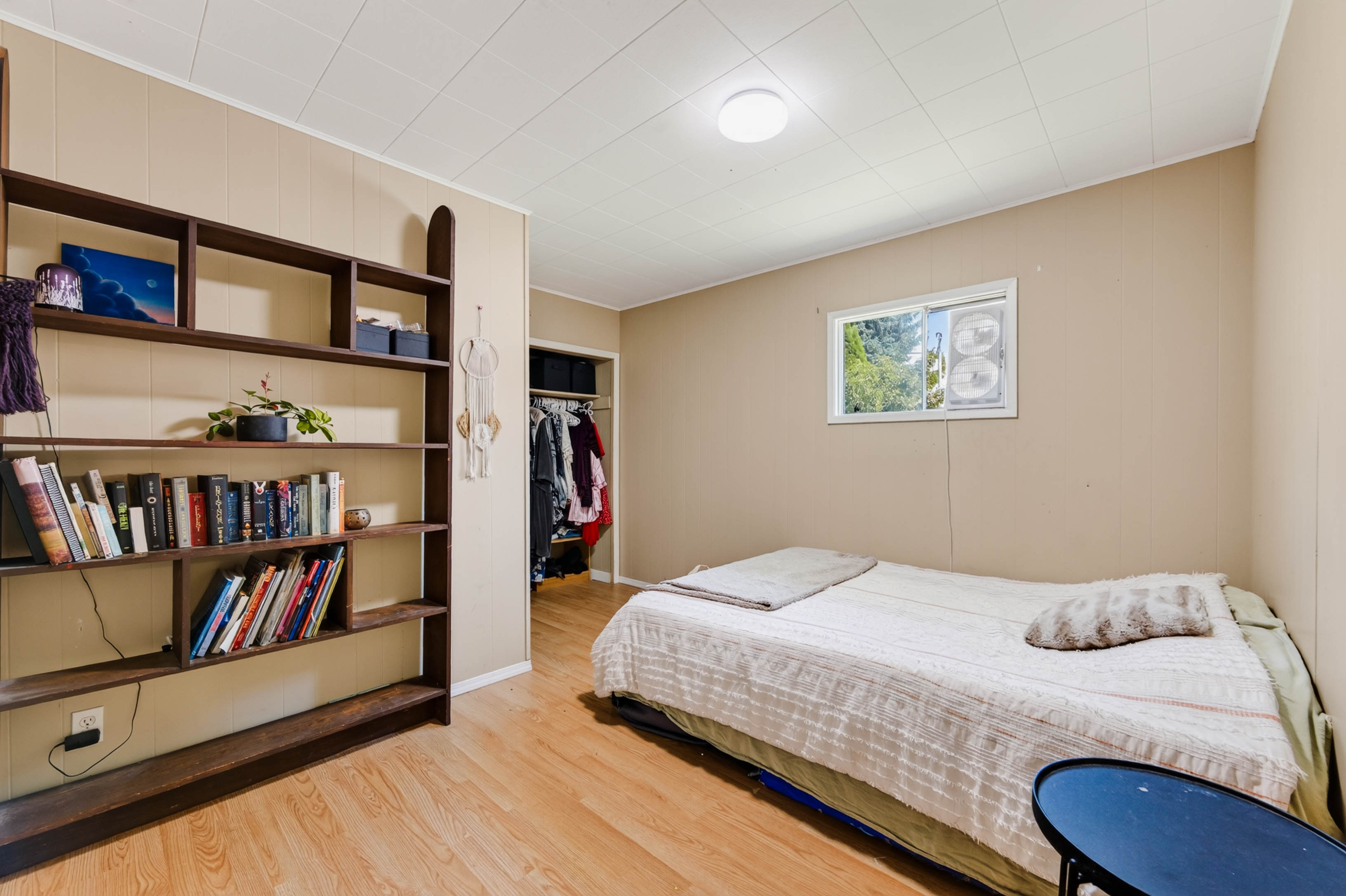 Bedroom with built-in shelving and natural light