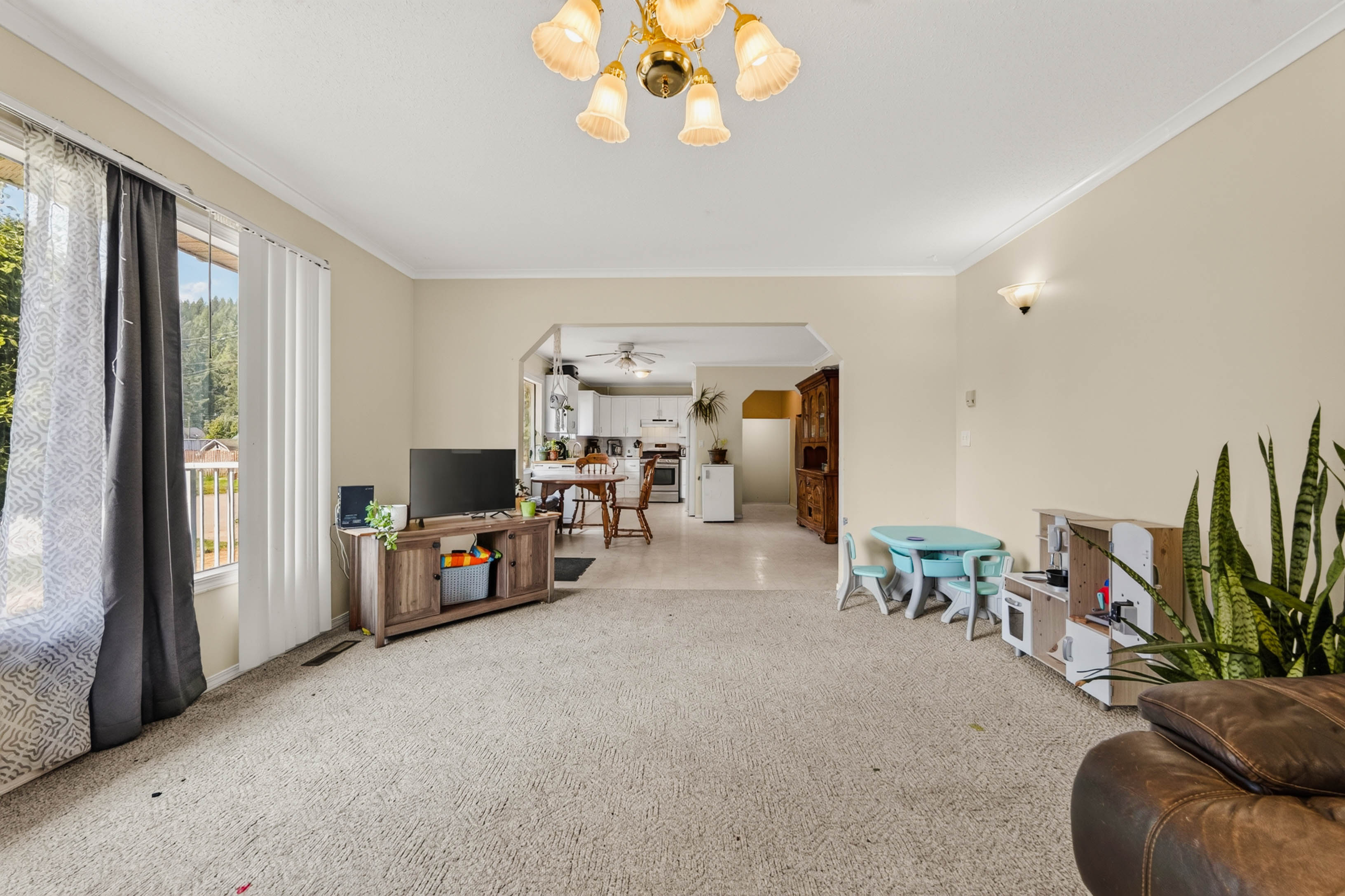 Bright living room opening toward the kitchen and dining area