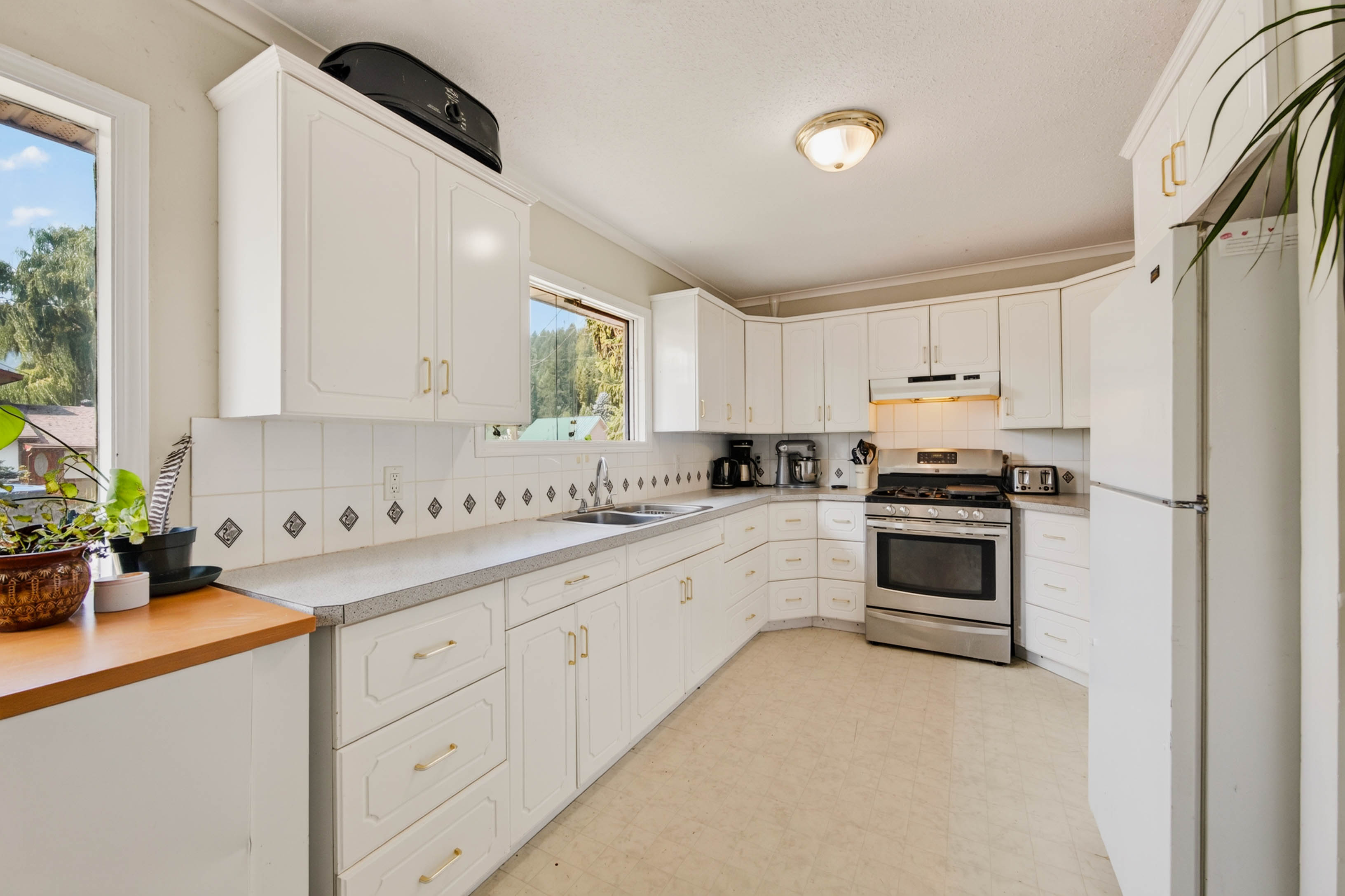 Wide view of the bright white kitchen