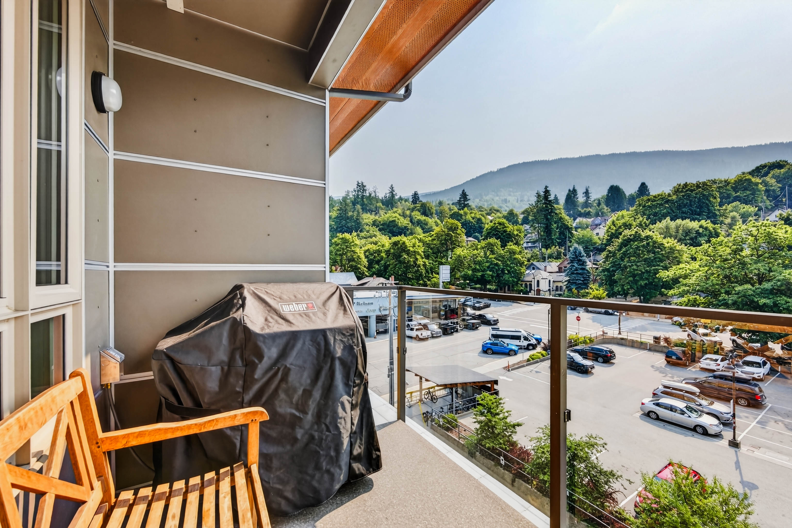 Covered balcony with city and mountain views at Unit 408 Nelson Commons