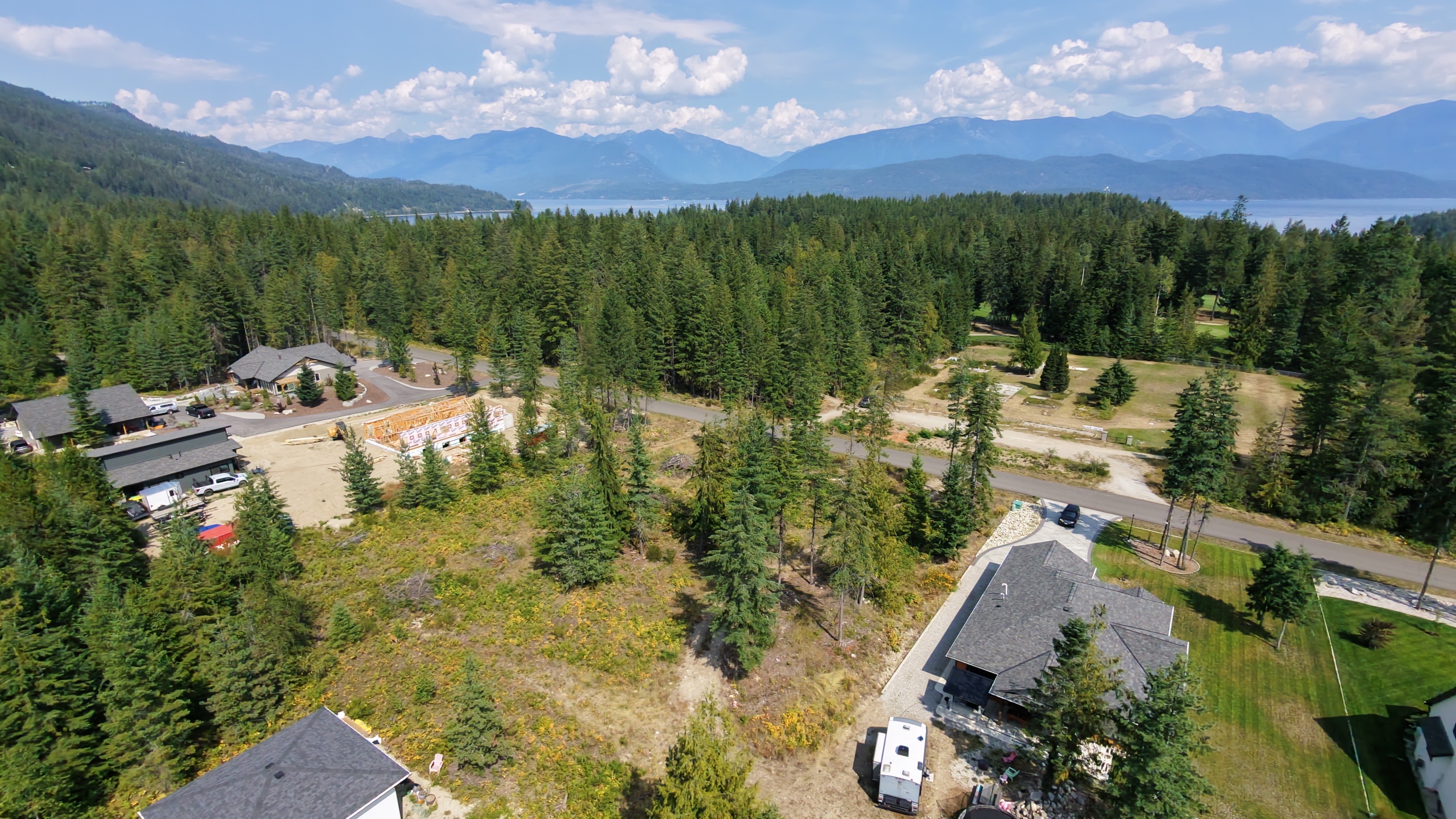 Aerial view of Lot 4 Queens Bay Road in Balfour with forest, mountains and Kootenay Lake beyond