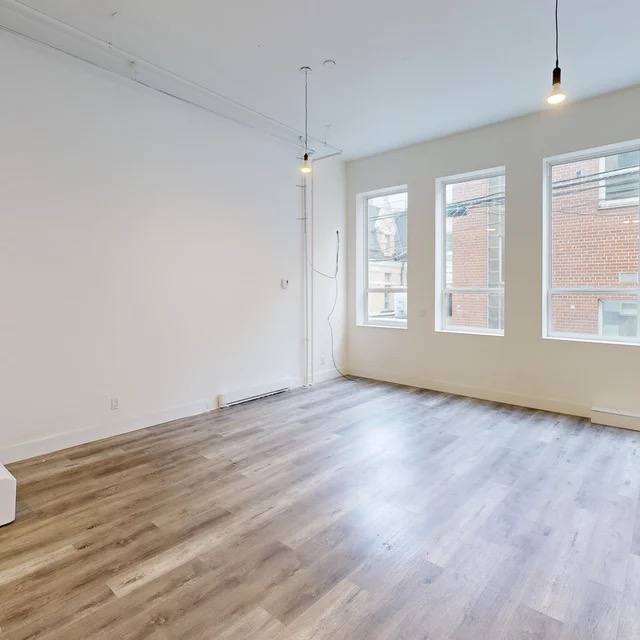 Open professional workspace with large windows at 2-533 Baker Street