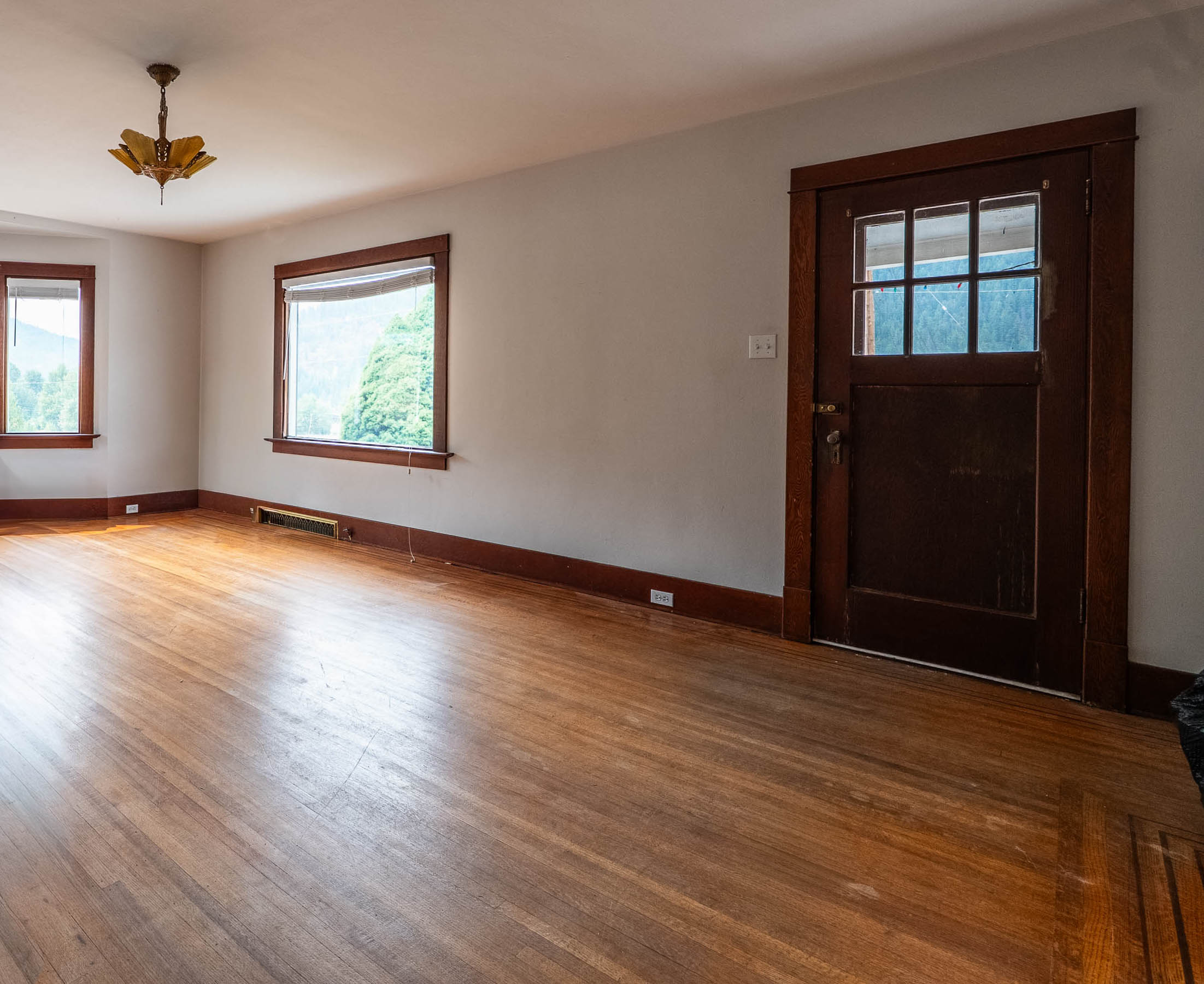 Interior living space with hardwood flooring and original wood trim