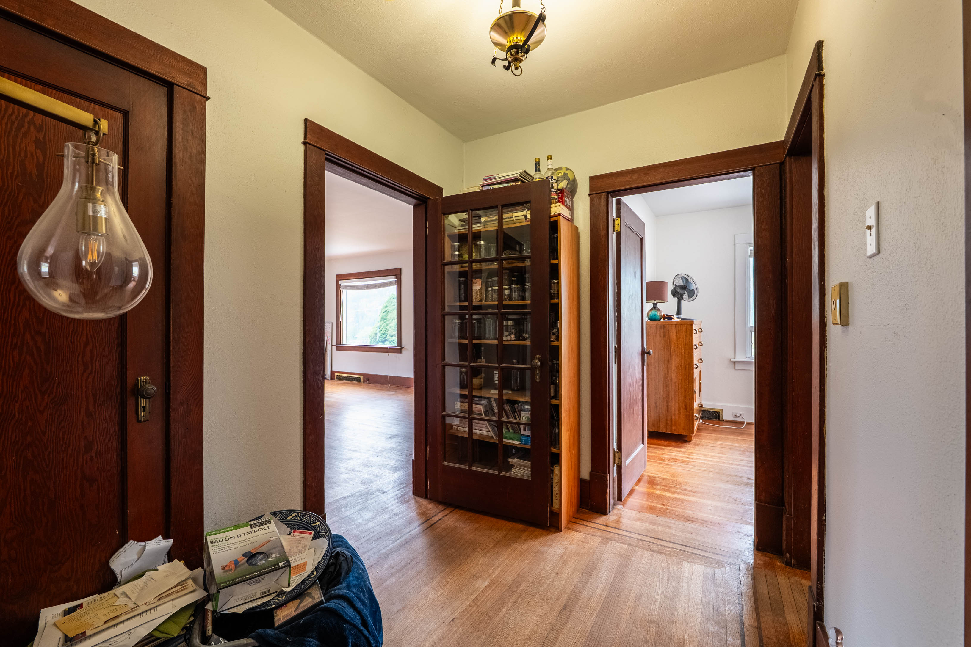 Interior hallway with hardwood flooring and wood trim