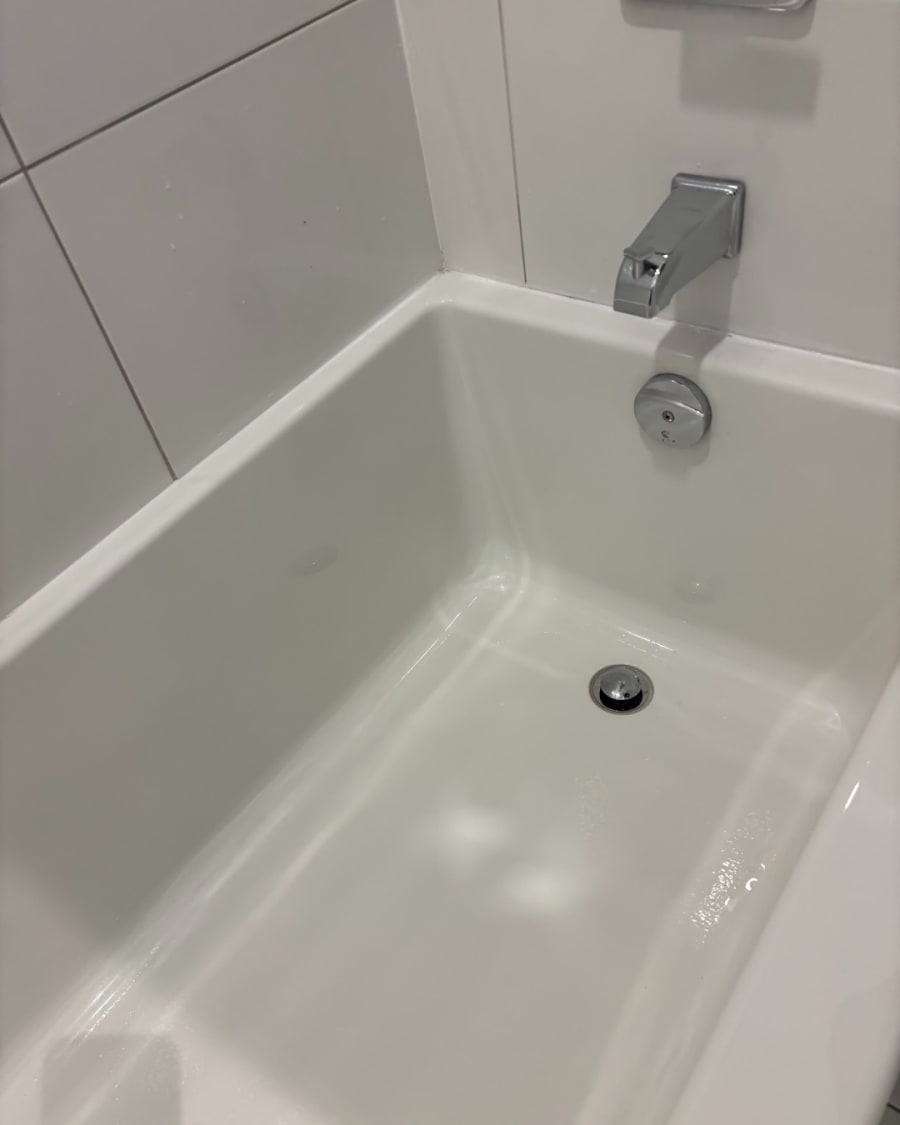 The same shower, glass and tile sparkling after a Zamora clean
