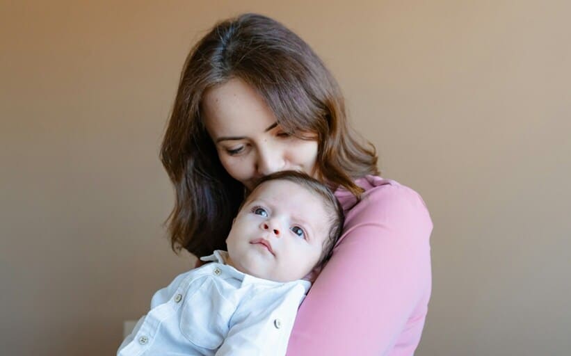 mother holding baby
