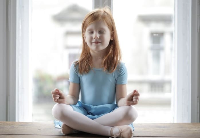 child doing meditation