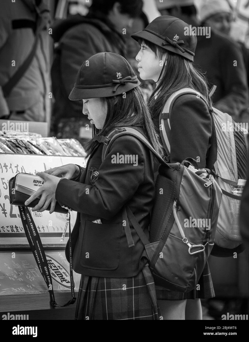 Two Japanese school girls walking down Matsubara Dori street in Kyoto ...