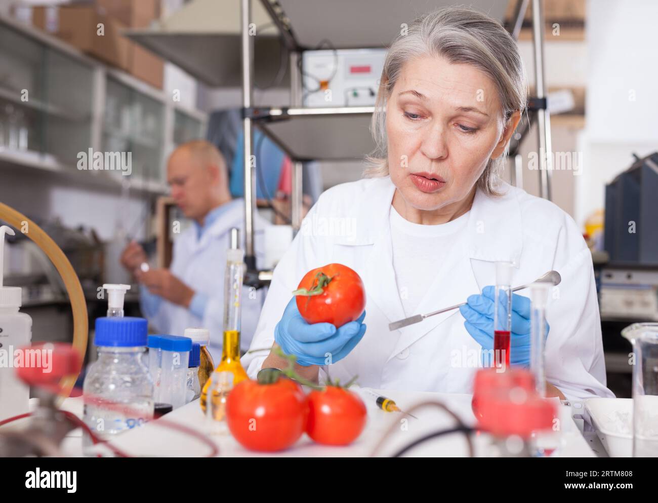 Woman biochemist checking fruits and vegetables Stock Photo - Alamy