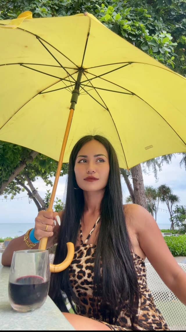 Yupa's stylish pose with a yellow umbrella