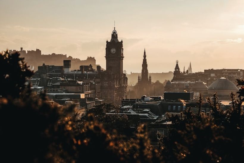 A landscape picture of Edinburgh, with the castle and Balmoral clock tower prominently shown