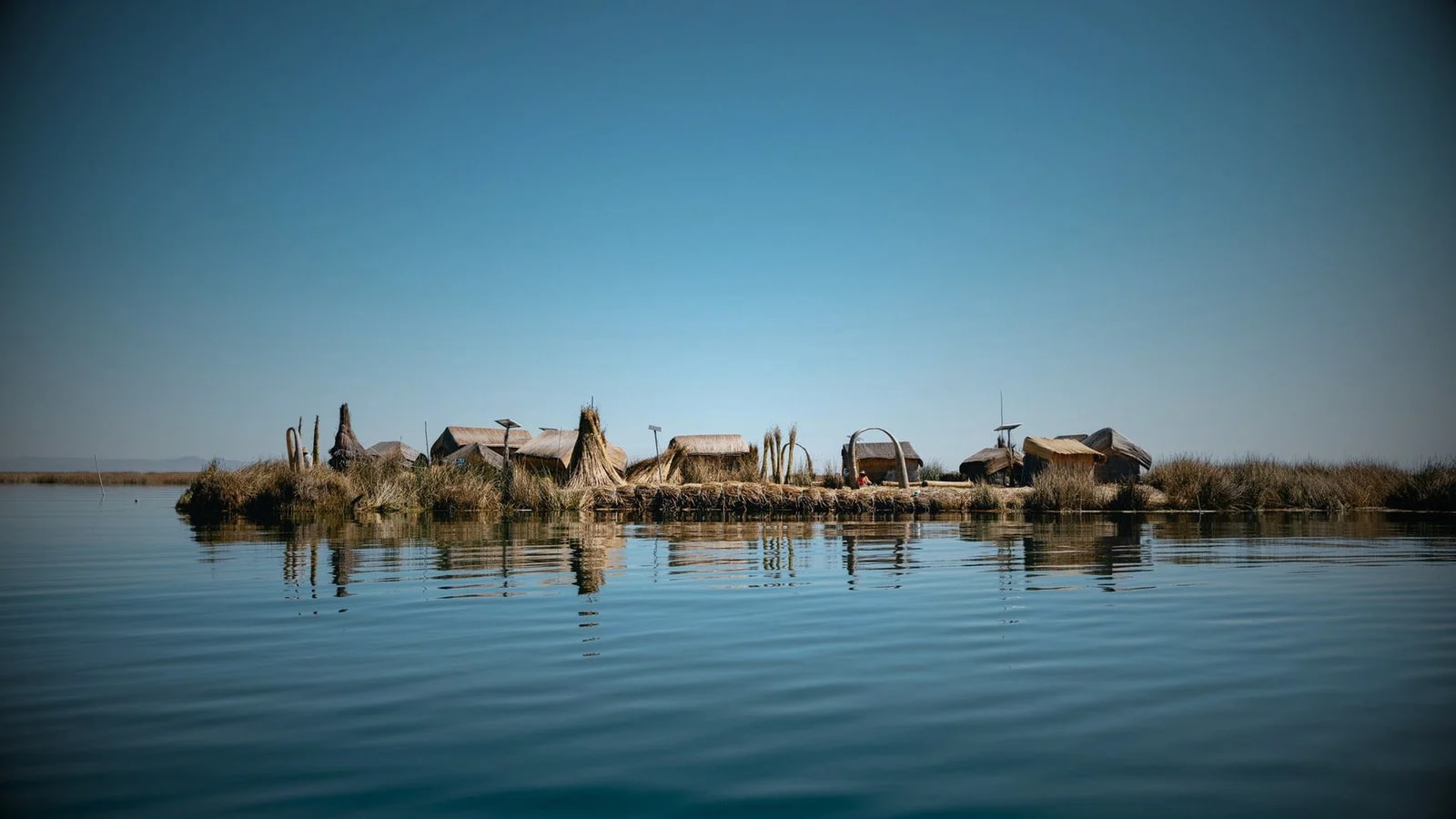 Lake Titicaca at golden hour with totora reed boats