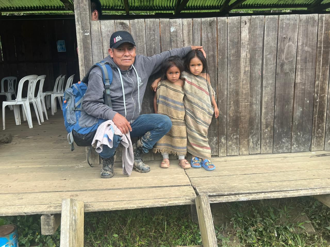 A guide with children wrapped in blankets