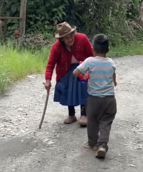 An elder greeting a child on a country path