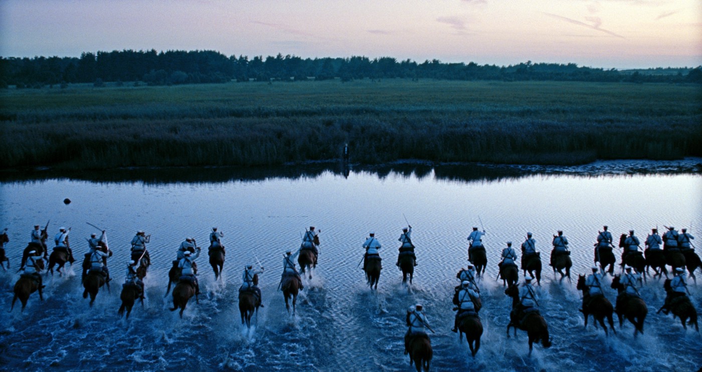 A picture of a bunch of warriors on horses crossing a river