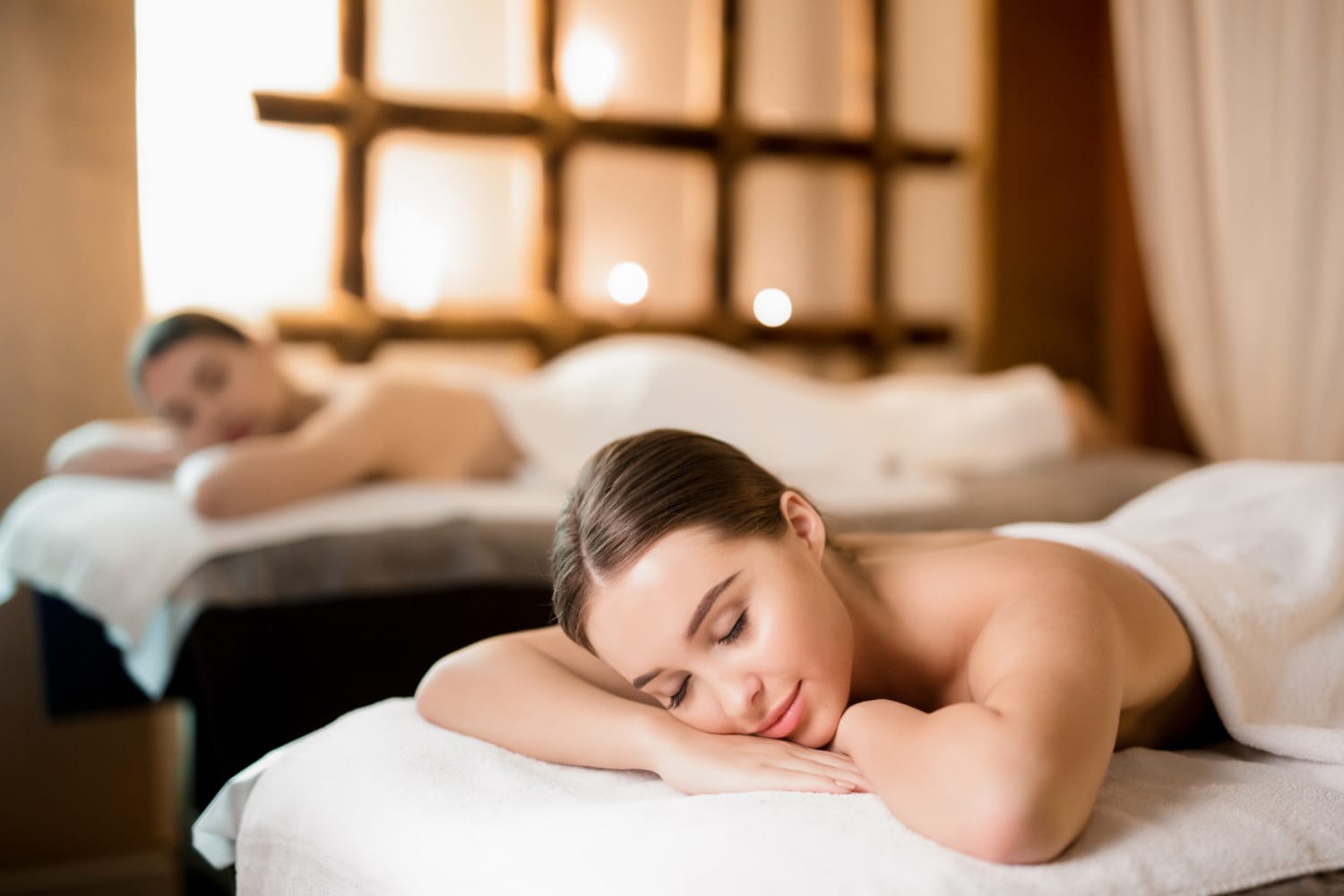 Woman lying on her front having a back massage