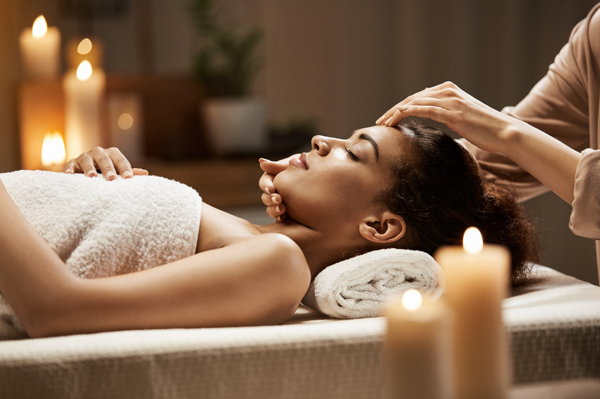 Woman lying on her back having a face massage
