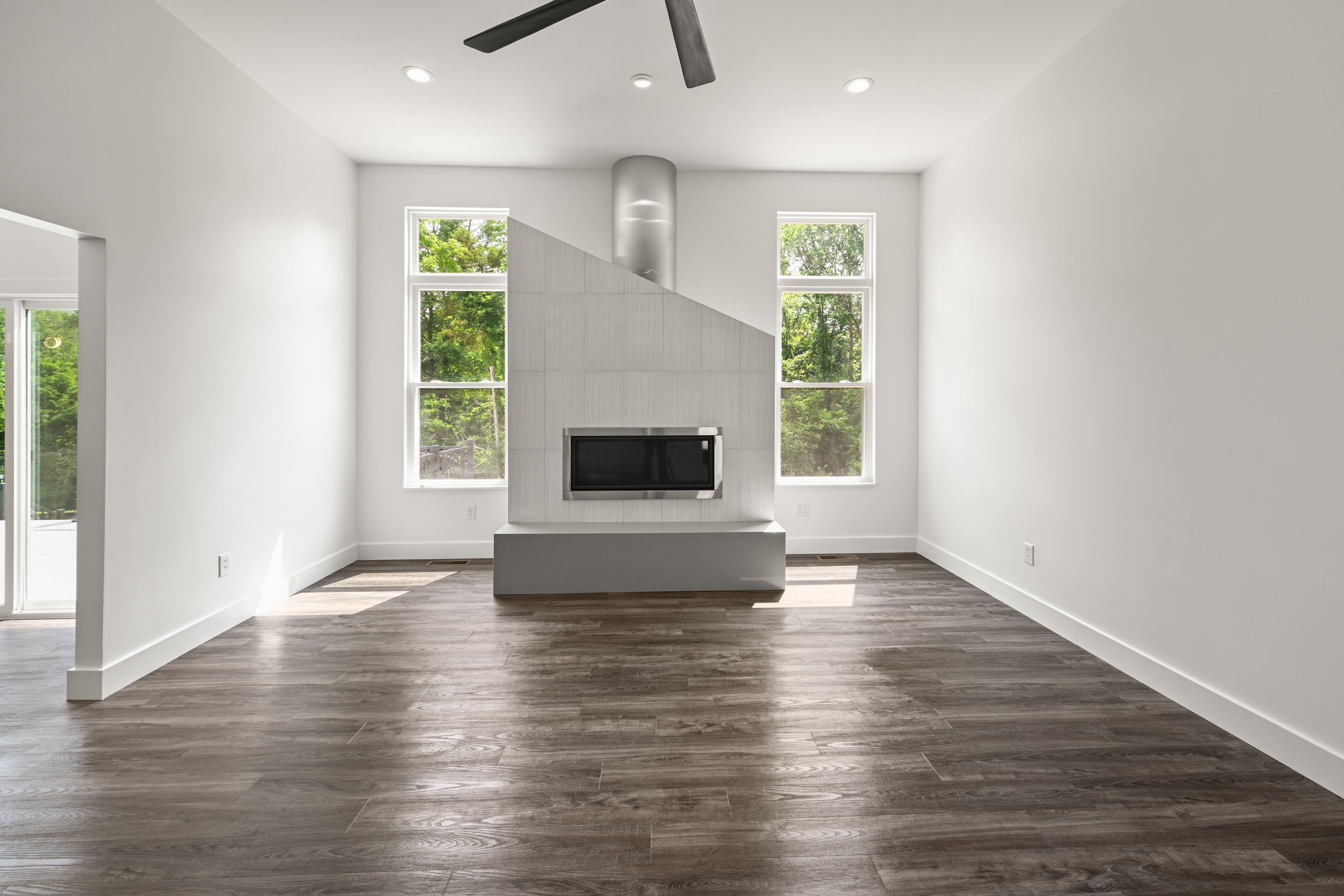 Stainless steel appliances and custom range hood in kitchen