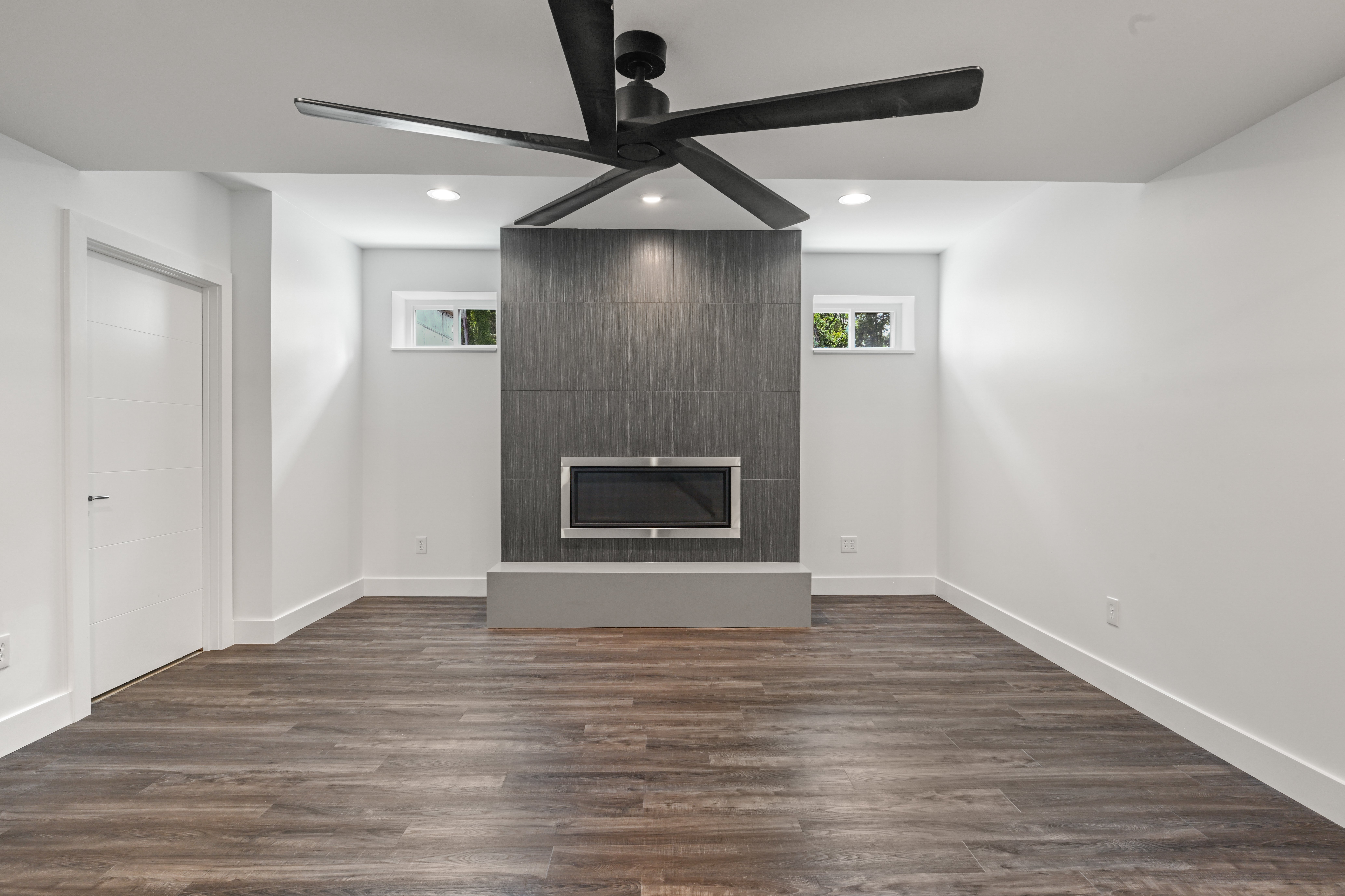 Basement wet bar with cabinetry and quartz counters