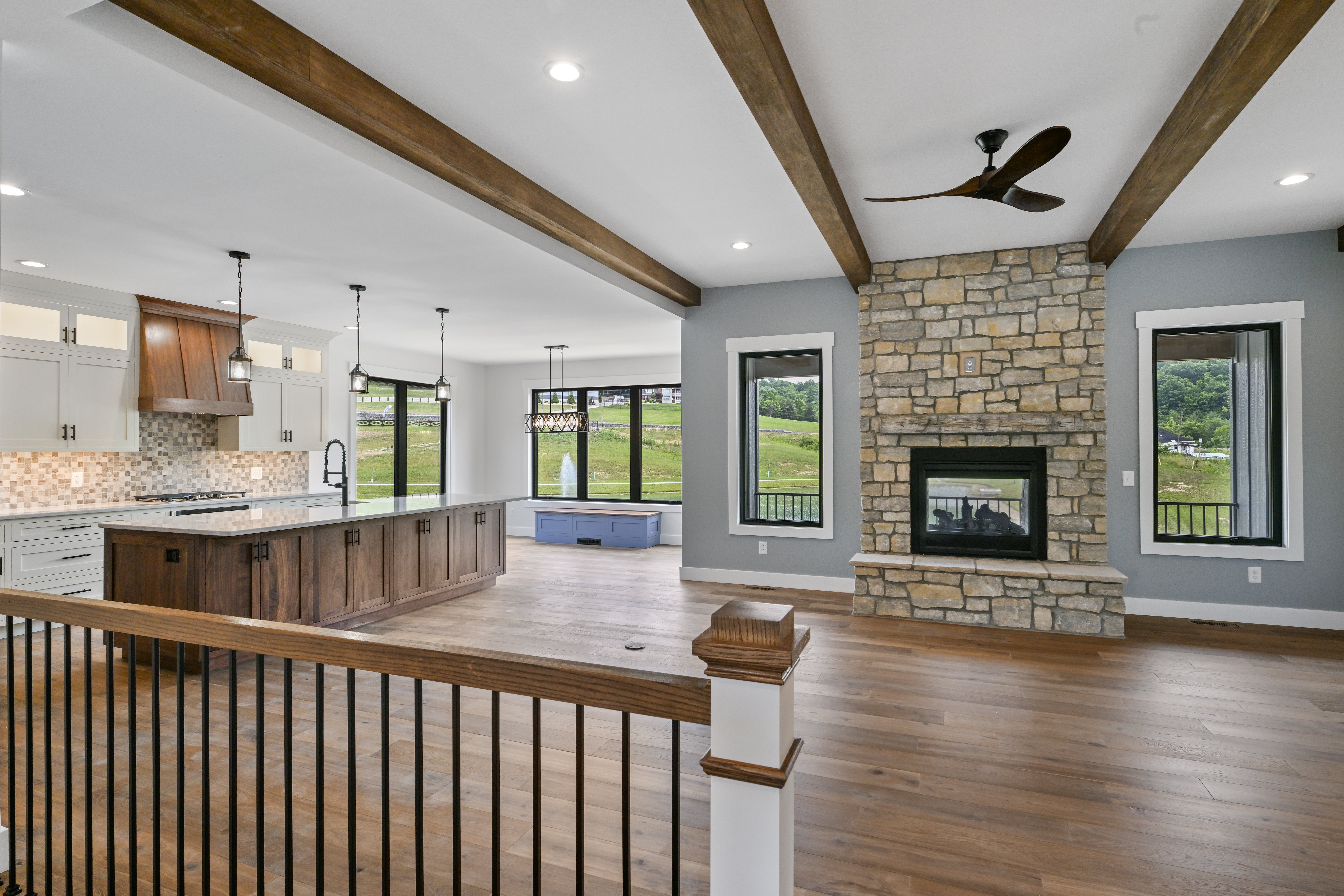 Spacious living room with hardwood floors and natural light