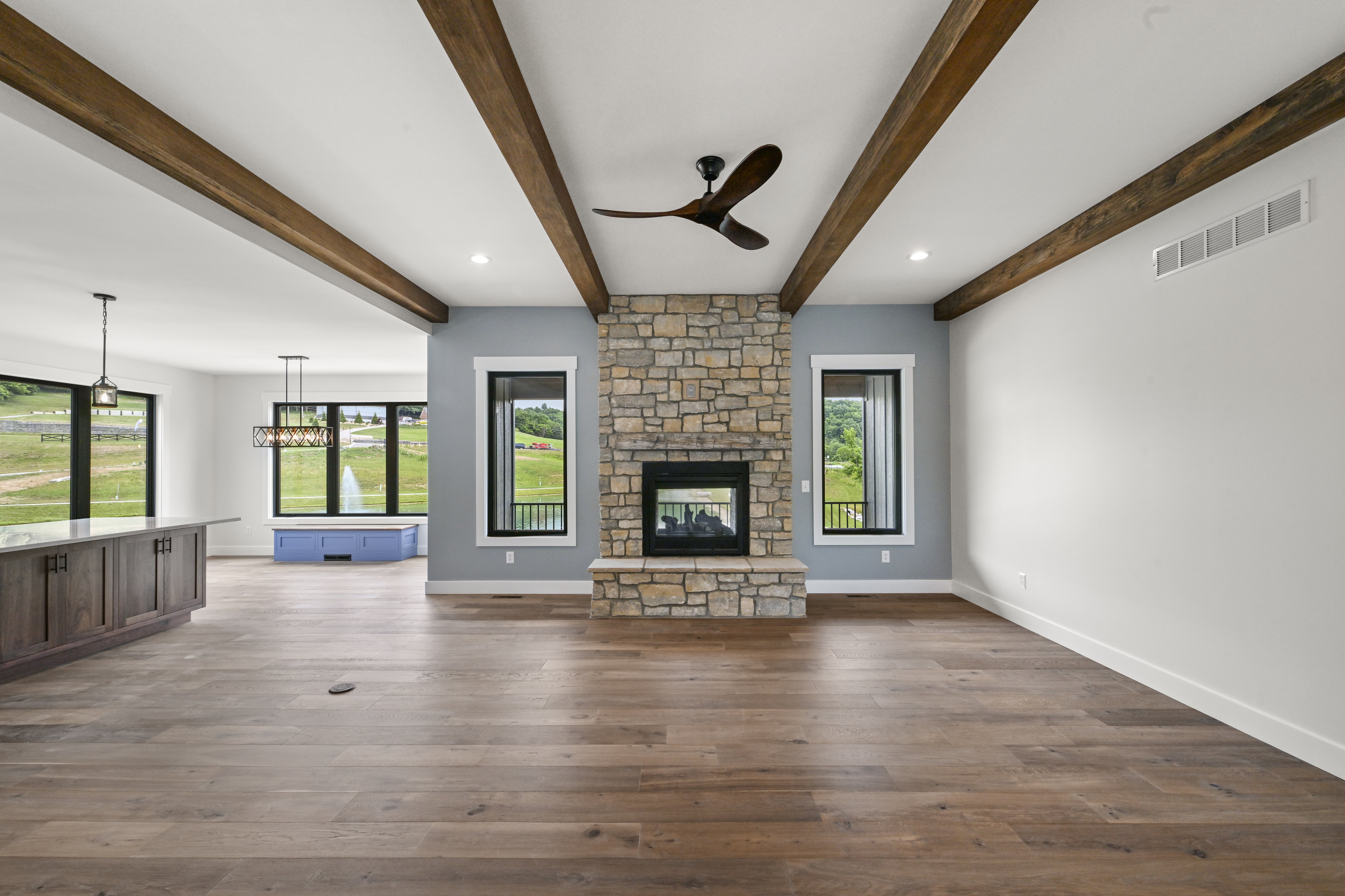 Great room looking toward kitchen in open floor plan custom home