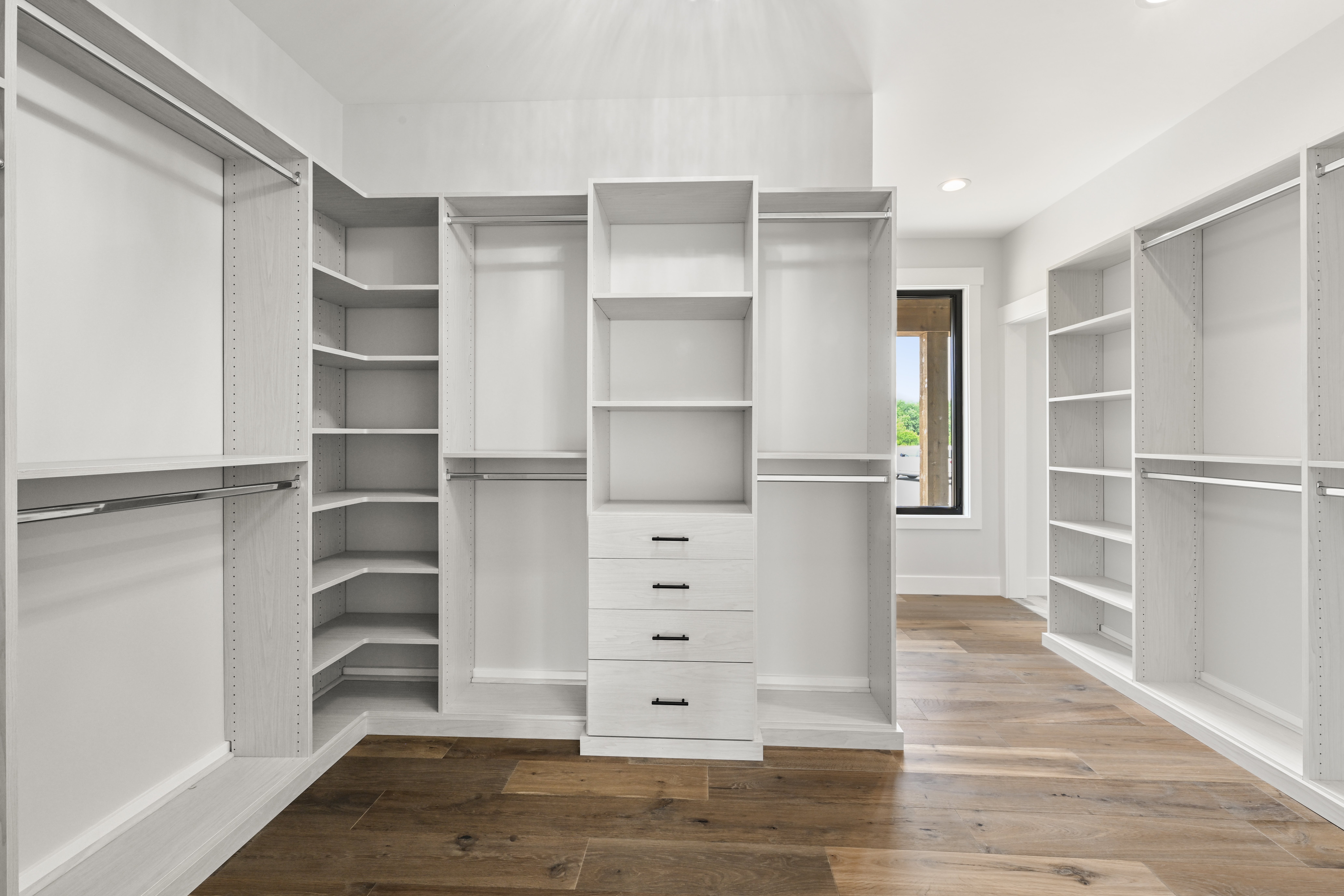 Master bedroom walk-in closet with custom organization system