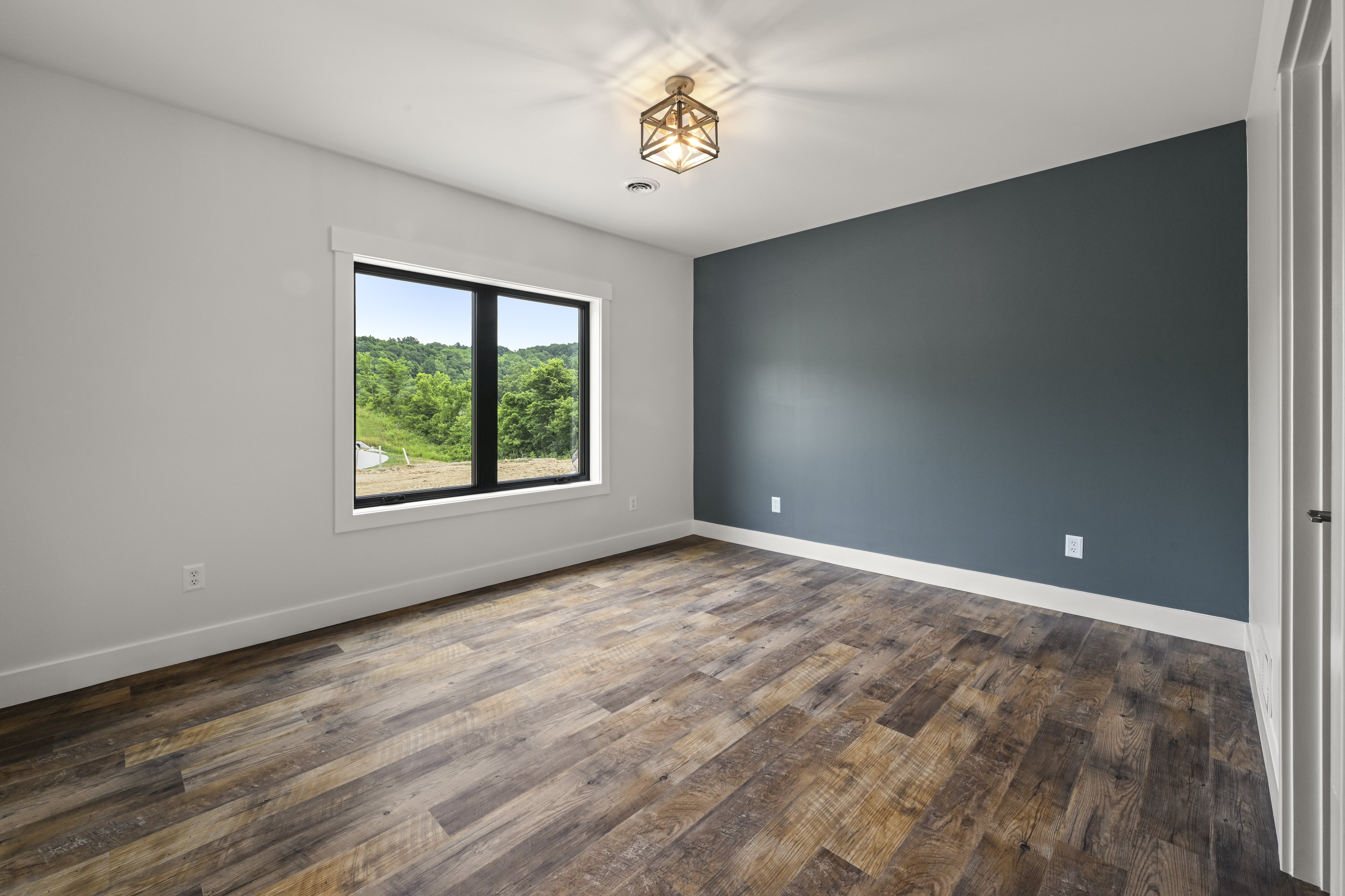 Guest bedroom with natural light in custom Indiana home
