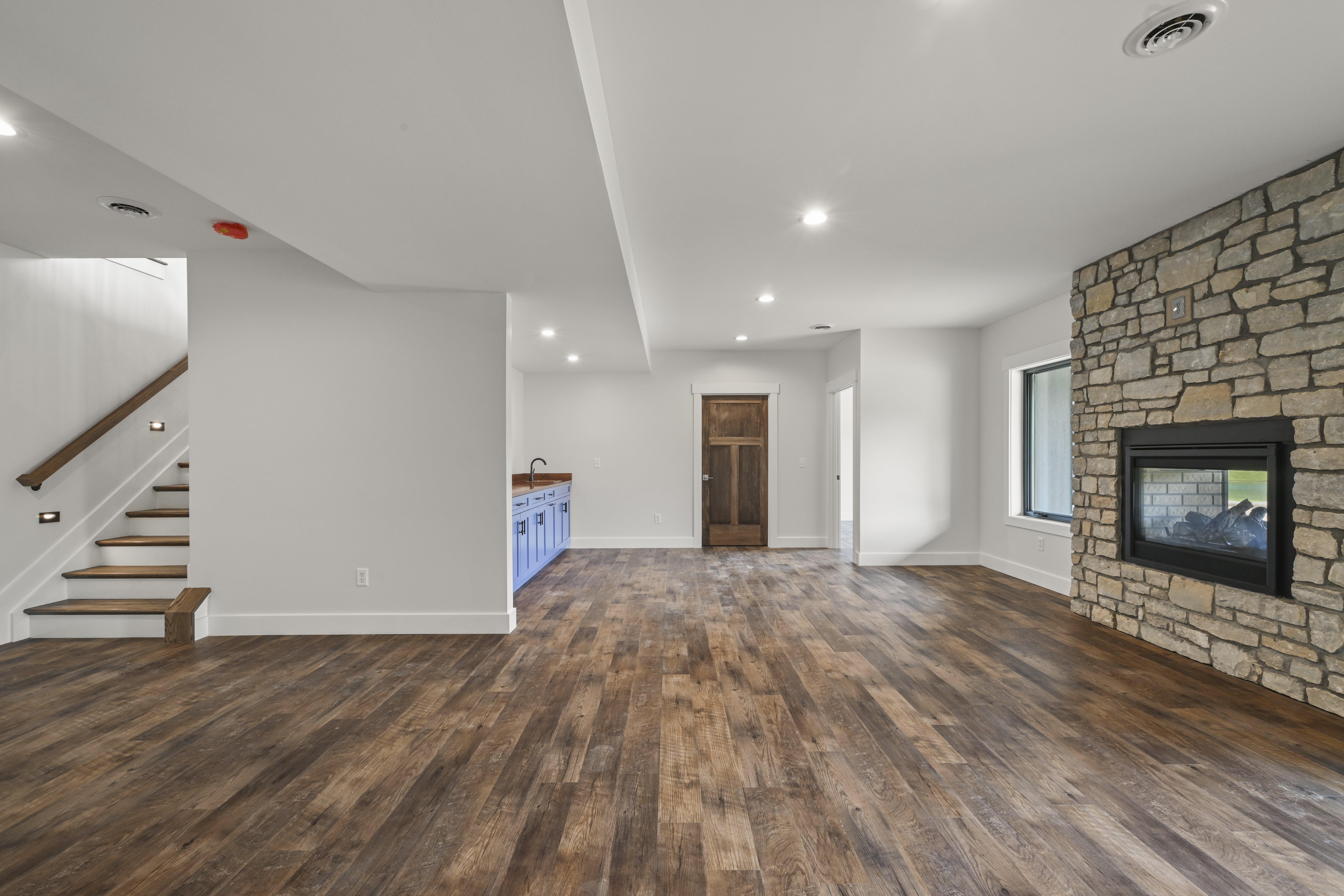 Second bedroom with closet and windows in Lawrenceburg home