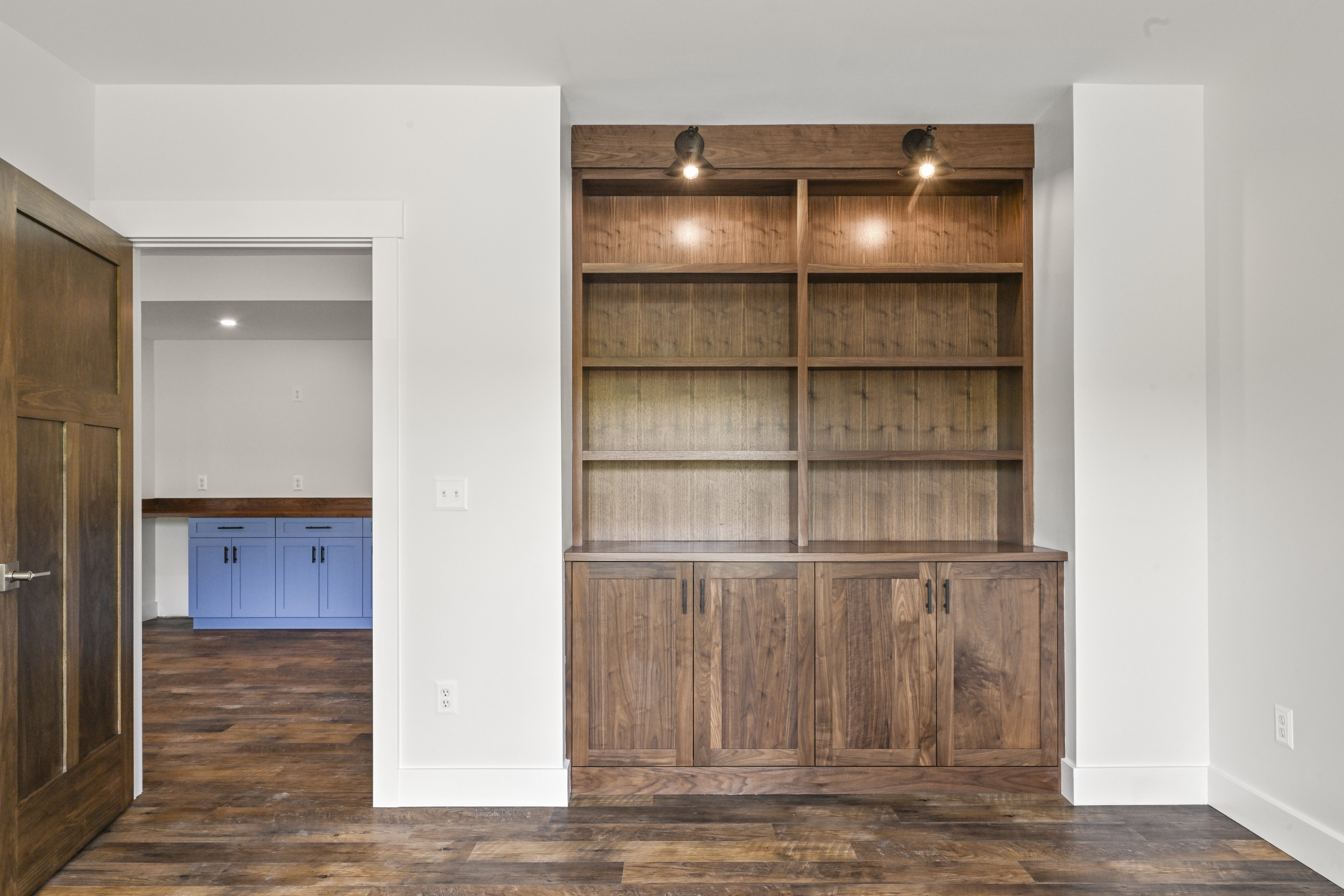 Home office with french doors and built-in desk in custom home