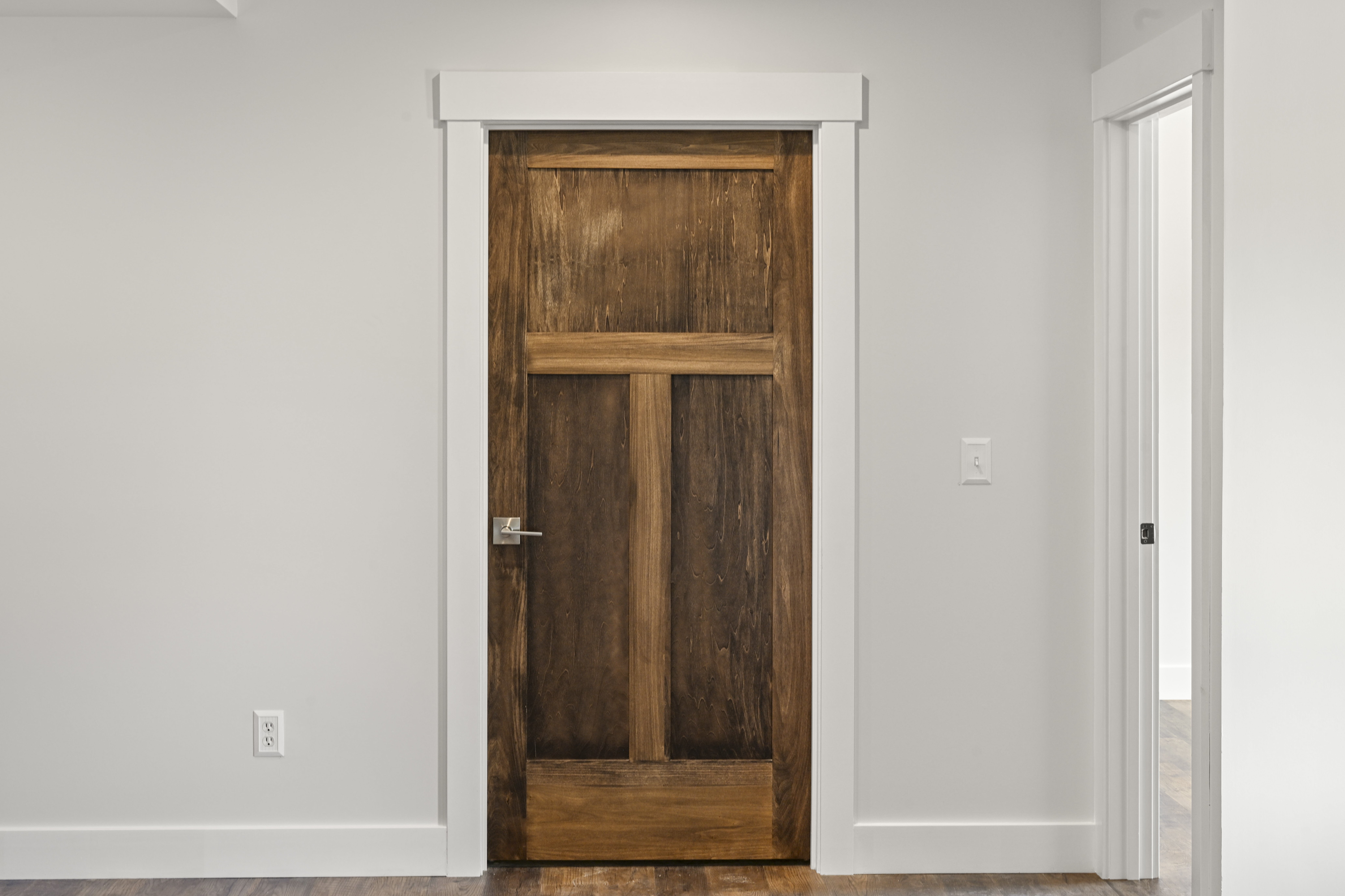 Hallway with hardwood flooring and trim detail in custom home