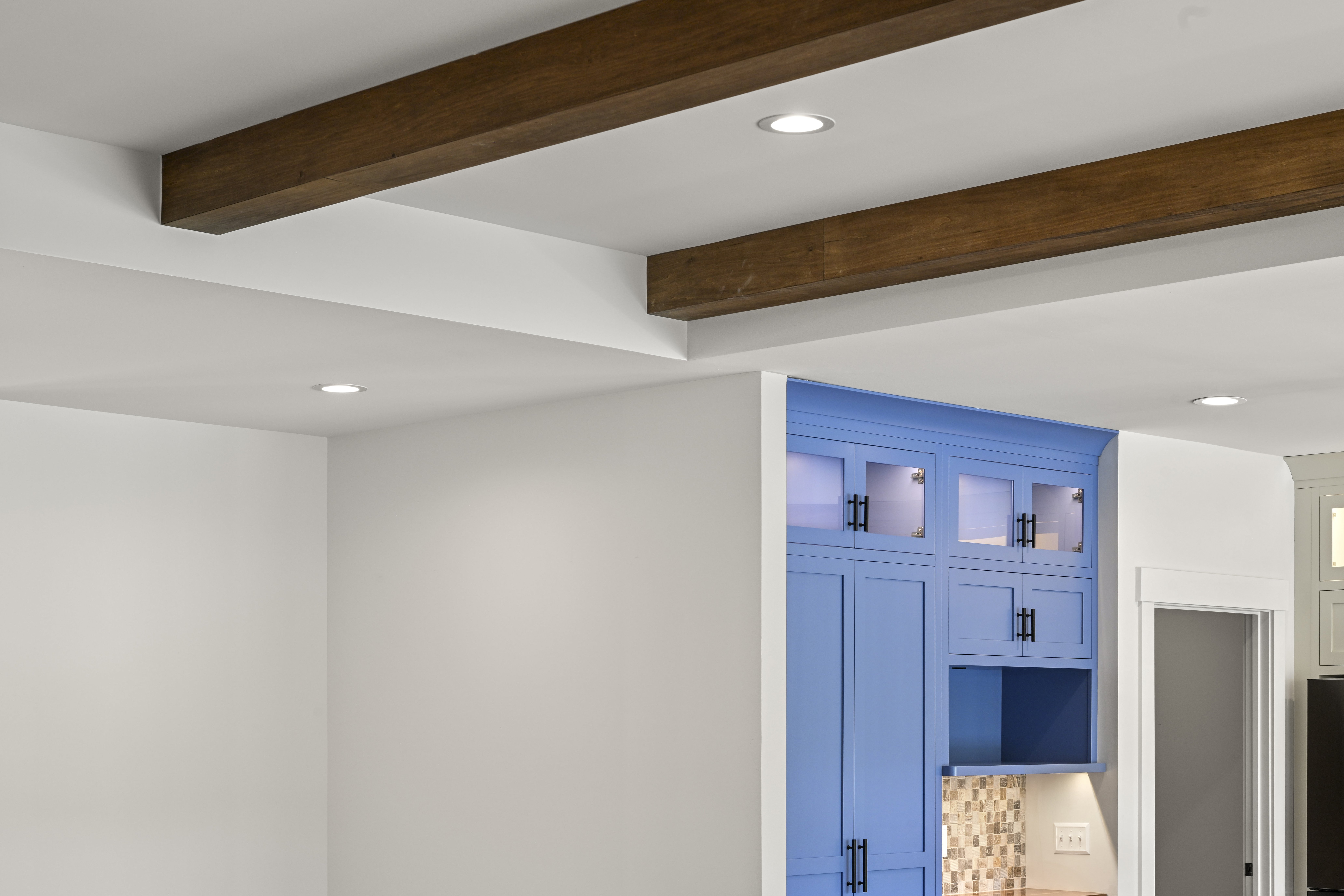 Basement home theater room with dark walls and sconces