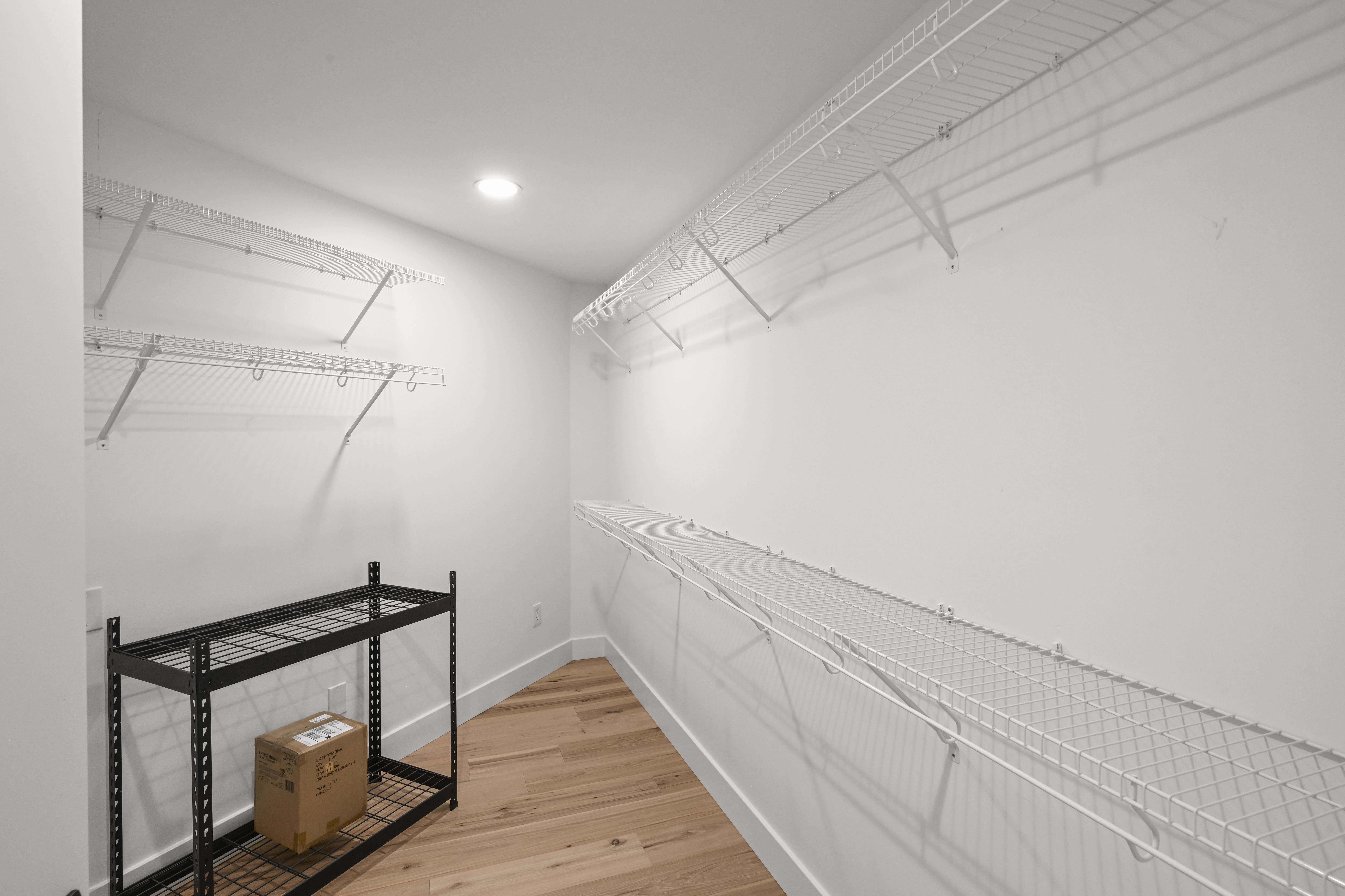 Master closet with custom shelving in Perfect residence