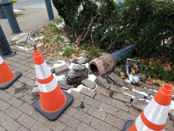 Driver Runs Red Light on Main St, Causes Another to Jump Curb and Crash into Post