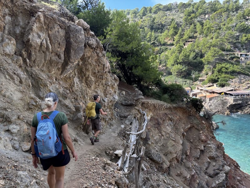 The trail narrows to a ledge. Below: the clearest water I've ever seen.