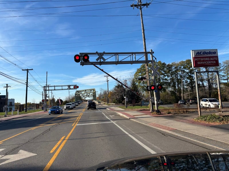 Lights flashing, gate stuck halfway, and no train anywhere in sight.