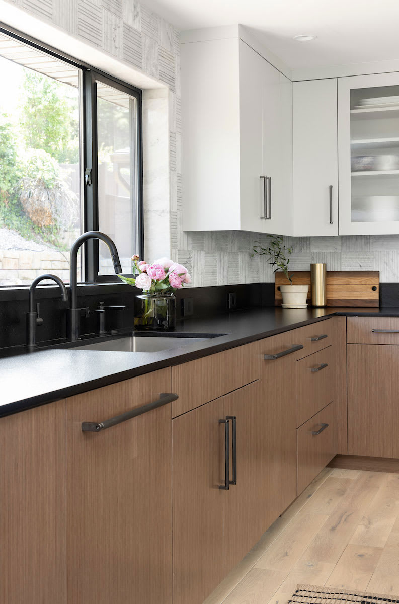 Modern bungalow kitchen with bright windows.
