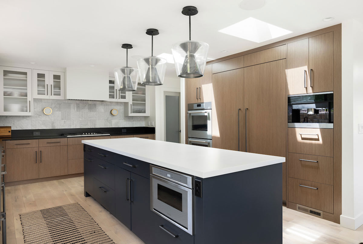 Kitchen with center island modern design featuring wood grain paneling for cabinets.
