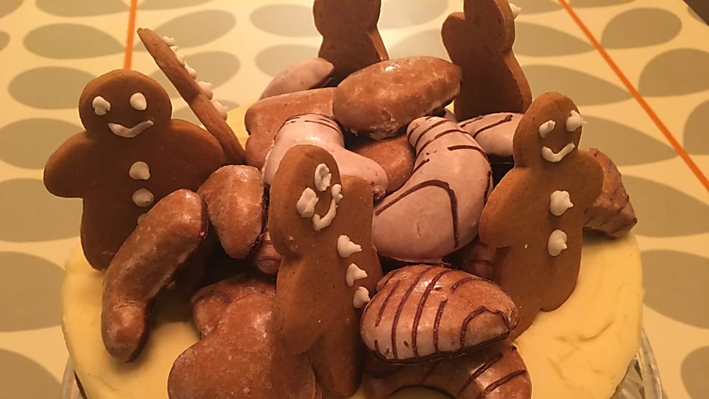 Chocolate Ginger Cake with a white chocolate ganache and gingerbread men and lebkuchen biscuits on the top