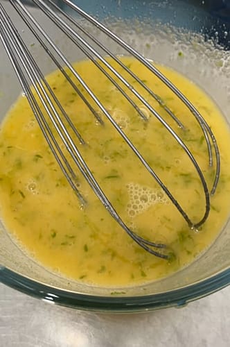 Sugar, lime zest, lime juice and egg yolks after they have been whisked