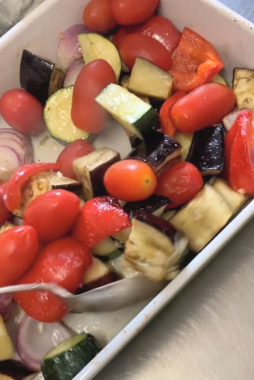 Roasted vegetables with tomatoes in a baking dish
