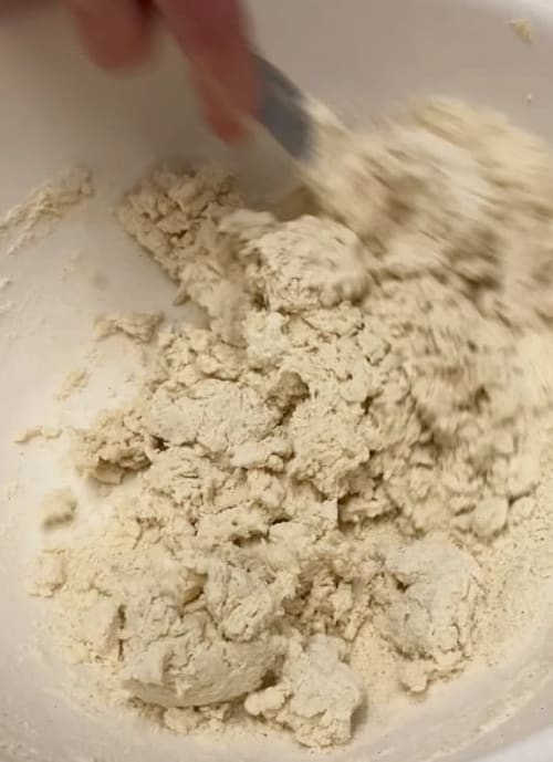 Flour mixture being mixed to a soft dough with the milk or buttermilk.