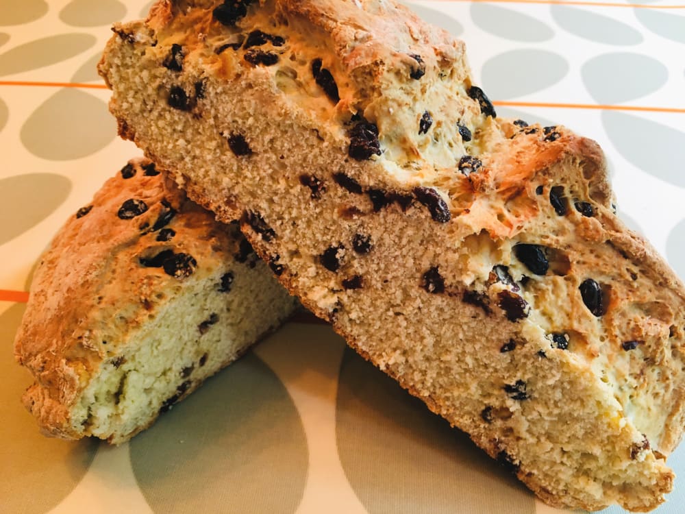 Fruited white soda bread cut in half on a table Fruited white soda bread cut in half on a table