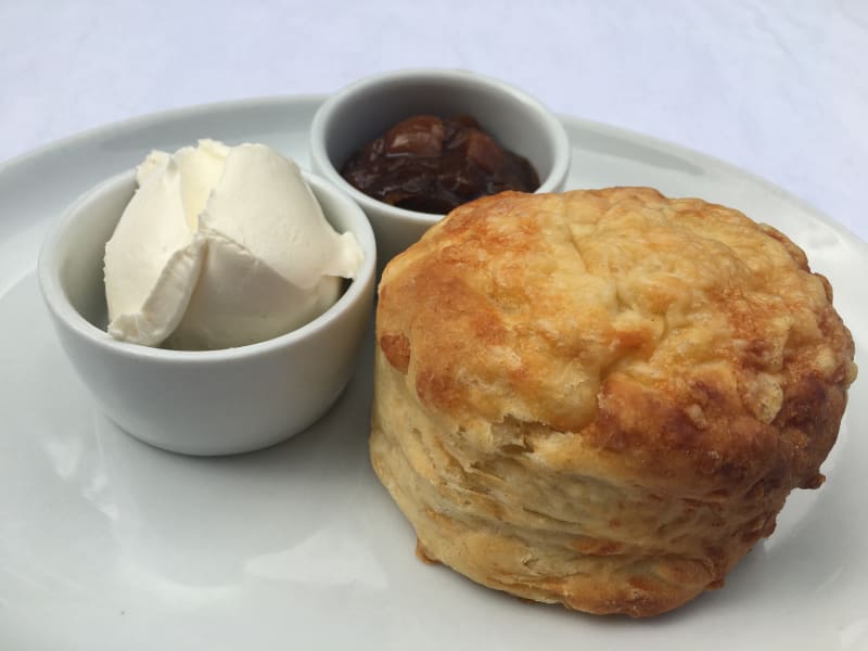 Cheese scone on a plate with chutney and cream cheese Cheese scone on a plate with chutney and cream cheese