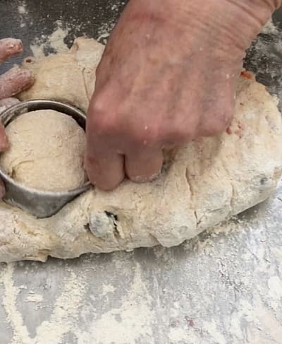 Cutting out scones from the uncooked dough mixture