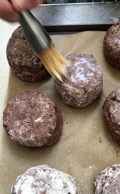 Milk being brushed onto the top of a chilli and chocolate scone