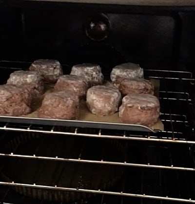 Scones on a baking tray on the shelf of an oven