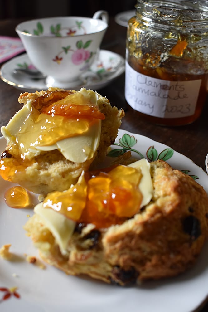 King Charles' Scones served with butter and marmalade and flowery tea cup and jar of homemade marmalade