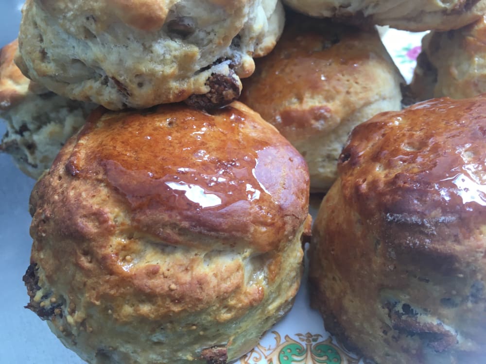 Group of Fig and honey scones on a plate with glistening honey covering the scones.